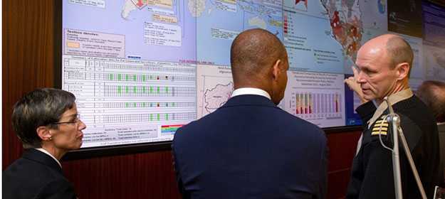 CDC investigator discusses data with two individuals