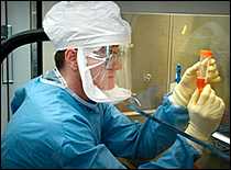 Scientist in protective gear working in a laboratory Scientist in protective gear working in a laboratory