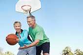 Older adults playing basketball
