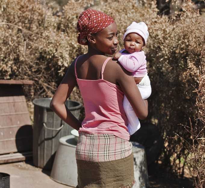 Young mother holding her child in her arms