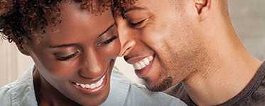 Man and woman smiling and showing affection.