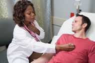 Doctor listening to heart of patient