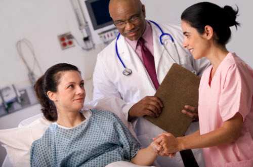 Nurse and doctor talking to a patient