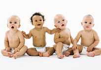 4 smiling babies sitting together